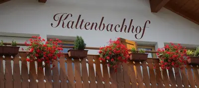 a fence with potted plants on top of it at Ferienwohnungen Kaltenbachhof - Urlaub auf dem Biobauernhof in Parcines