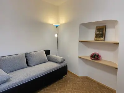 a living room with a couch and a lamp at Ferienwohnungen Kaltenbachhof - Urlaub auf dem Biobauernhof in Parcines