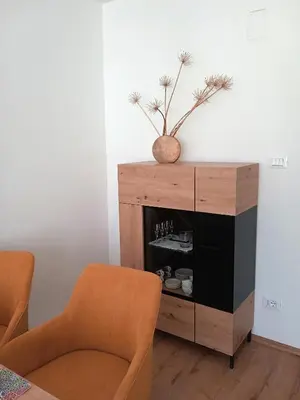 a living room with two chairs and a wooden cabinet at Apartment Himmelreich 29 in Plaus