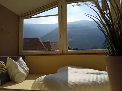 a bedroom with a window with a view of a mountain at Apartment Himmelreich 29 in Plaus