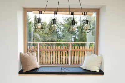 a window seat with three pillows and three lights at Alone in Chalet with view on Dolomites in Villandro