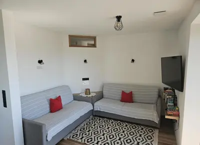 two gray couches sitting in a living room at Alone in Chalet with view on Dolomites in Villandro