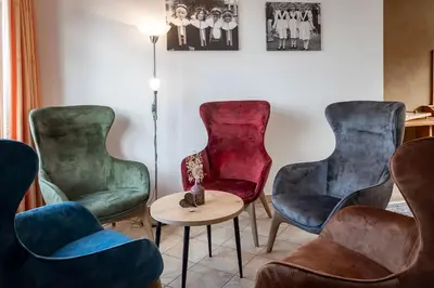 a room with three chairs and a table at Treffhof in Siusi