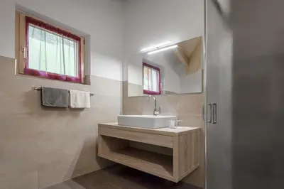 a bathroom with a sink and a mirror at Ciasa de Lenz in San Cassiano