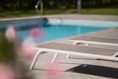 a picnic table next to a swimming pool at Pension Siller in Lagundo