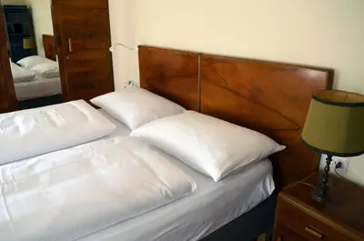 a bedroom with a bed with two pillows on it at Villa Iolanda in Merano