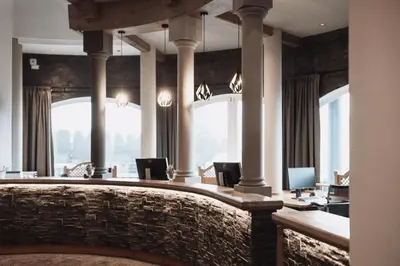 a desk with a chair with a tablet on it at Montis - Active Nature Resort in Brunico