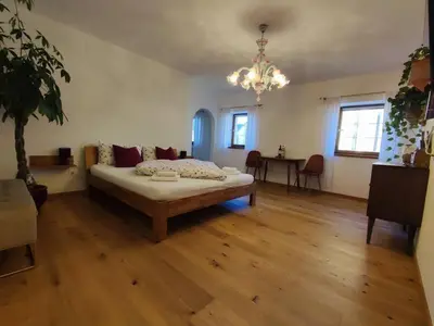 a large room with a bed and a table at Gemütliches Studio mit Garagenparkplatz in Vols am Schlern