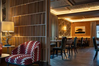 a restaurant with tables and chairs and a bar at Eight Cortina in Cortina dʼAmpezzo