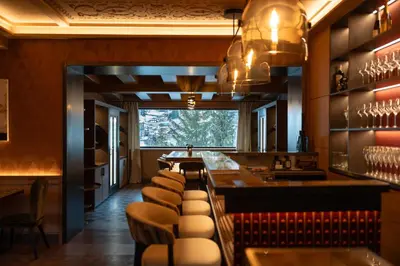 a restaurant with tables and chairs in a room at Eight Cortina in Cortina dʼAmpezzo