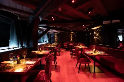 a living room with couches and chairs and tables at Eight Cortina in Cortina dʼAmpezzo