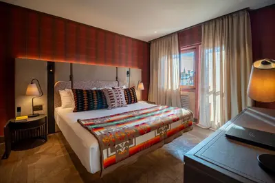 a large living room with a couch and chairs at Eight Cortina in Cortina dʼAmpezzo