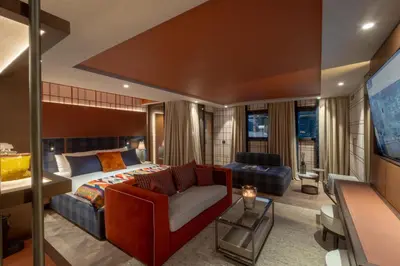 a bedroom with a couch and a bed in a room at Eight Cortina in Cortina dʼAmpezzo