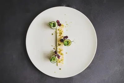 a plate with a letter on it with food on it at Parkhotel Marlena - Adults Only in Merano