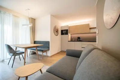 a living room with a couch and a table at Residence aMoret in Bressanone