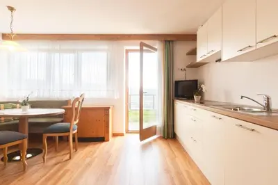 a kitchen with a table and a kitchen with a dining room at Wargerhof - Urlaub auf dem Bauernhof in Meltina