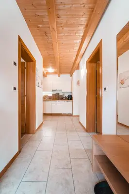 a kitchen with a wooden ceiling and a wooden table at ALMRESIDENZ UNTERRAIN - with FREE SKI BUS SHUTTLE in Valdaora