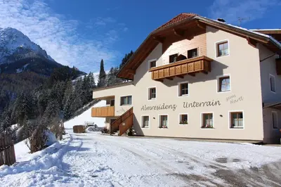 a large deck with a view of mountains at ALMRESIDENZ UNTERRAIN - with FREE SKI BUS SHUTTLE in Valdaora