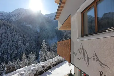 a window in a room with a mountain view at ALMRESIDENZ UNTERRAIN - with FREE SKI BUS SHUTTLE in Valdaora