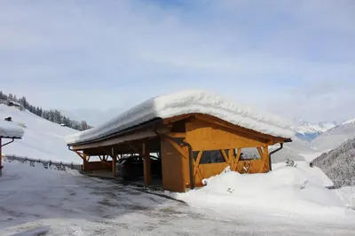 a deck with two chairs and a view of mountains at ALMRESIDENZ UNTERRAIN - with FREE SKI BUS SHUTTLE in Valdaora