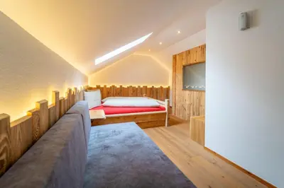 a room with a view of a snowy mountain at ALMRESIDENZ UNTERRAIN - with FREE SKI BUS SHUTTLE in Valdaora