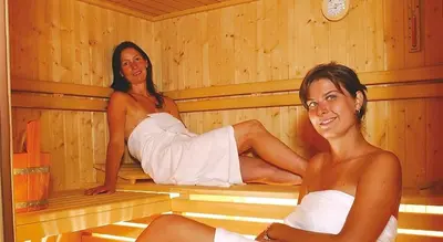 two women are sitting in a sauna at Residence Landhaus Rainer in Ridanna