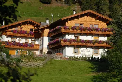 a house with flowers on the balconies of it at Residence Landhaus Rainer in Ridanna
