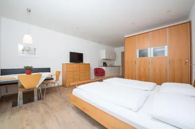 a bedroom with a bed and a desk and a table at Apartment Edelweiss in Brunico