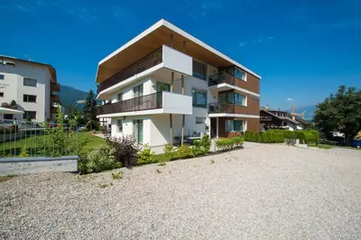 a large apartment building with a gravel driveway at Apartment Edelweiss in Brunico