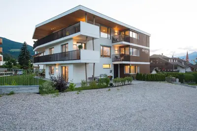 a large white house with a lot of windows at Apartment Edelweiss in Brunico