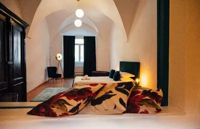 a bedroom with a bed and a room with a window at Franz Haus Apartments in Merano