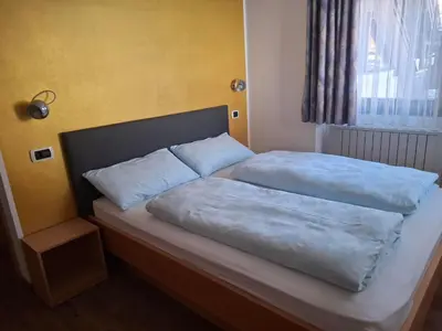 a bed with two pillows on it in a bedroom at Villa Sella in Selva di Val Gardena