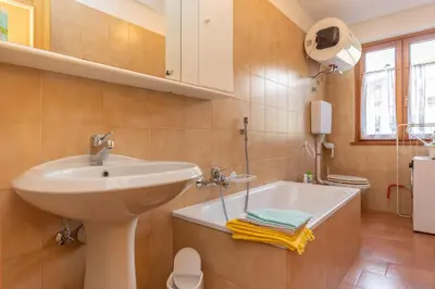 a bathroom with a sink and a bath tub at Casa Maura in Soraga