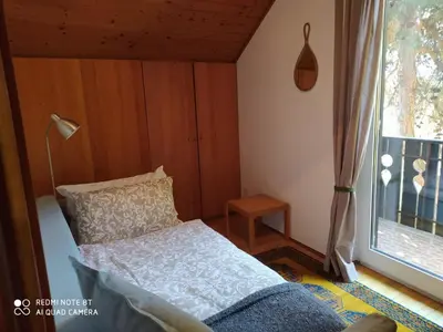 a small bedroom with a bed and a window at TORRE GARDEN HOME - casa singola nella città di Bolzano con giardino privato in Bolzano