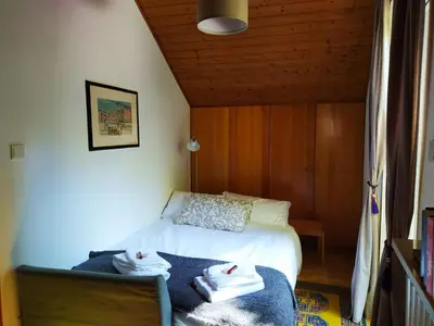 a bedroom with a bed with towels on it at TORRE GARDEN HOME - casa singola nella città di Bolzano con giardino privato in Bolzano