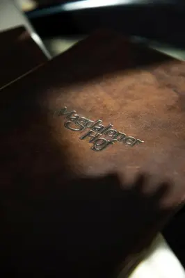 a close up of the word pizza written on a table at Hotel Magdalener Hof in Bolzano