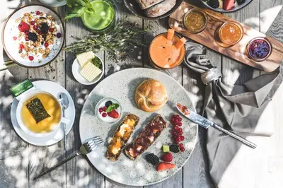 a table topped with plates of food and drinks at Hotel Magdalener Hof in Bolzano