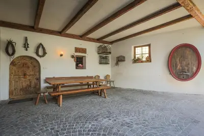 a room with a wooden bench and a table at Ansitz von Wohlgemuth in Salorno sulla Strada del Vino