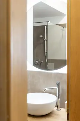 a bathroom with a white sink and a mirror at Ansitz von Wohlgemuth in Salorno sulla Strada del Vino