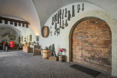 a room with a large wooden door and some antiques at Ansitz von Wohlgemuth in Salorno sulla Strada del Vino