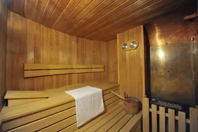 a wooden sauna with a towel on the side of it at Hotel Cristallo in Vigo di Fassa