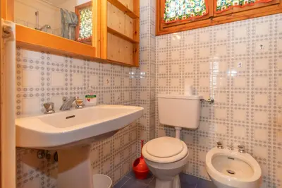 a bathroom with a toilet and a sink at Residence Marmolada in Pozza di Fassa