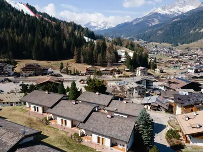 an aerial view of a village in the mountains at Residence Marmolada in Pozza di Fassa