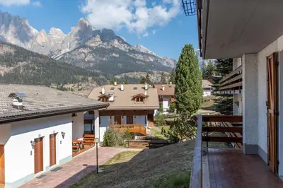 a view from the balcony of a house with mountains at Residence Marmolada in Pozza di Fassa
