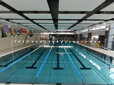 a large swimming pool with blue lanes in it at Dolomitihouse CASTAGNER in Fiera di Primiero