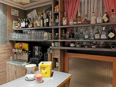 a bar with a lot of bottles of alcohol at Hotel Akelei in Brunico