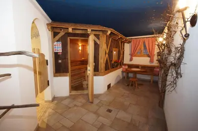 a hallway with a room with a door and a table at Hotel Akelei in Brunico
