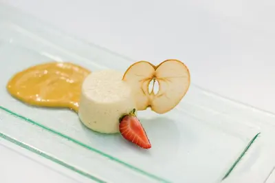 a piece of food with a strawberry on a plate at Naturhotel Gruberhof in Schenna