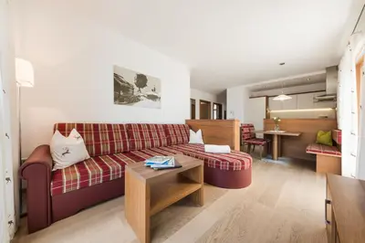 a living room with a couch and a table at Apartmenthaus Gruberhof in Schenna