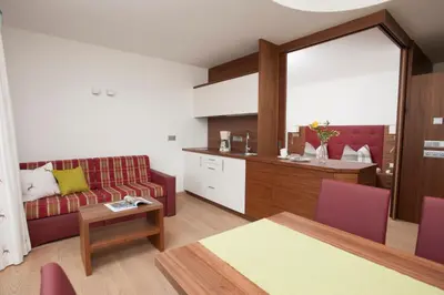 a living room with a couch and a table at Apartmenthaus Gruberhof in Schenna